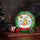 HARIBO Adventskalender mit Duftkerzen in grün und vor Weihnachtsdekoration stehend, gefüllt mit fruchtigen und süßen Teelichtern in verschiedenen Düften und Farben. Perfekt für die Vorweihnachtszeit.