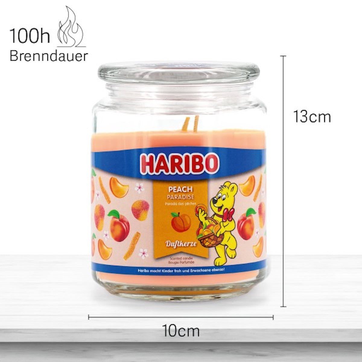 Haribo Duftkerze ‚Peach Paradise‘ (510g) im Glas - 13cm hoch, 10cm breit. Offizielle Lizenzkerze mit 100h Brenndauer, angenehmer Duft und liebevolles Haribo-Design. Dekoratives Wohnaccessoire und besonderes Geschenk.