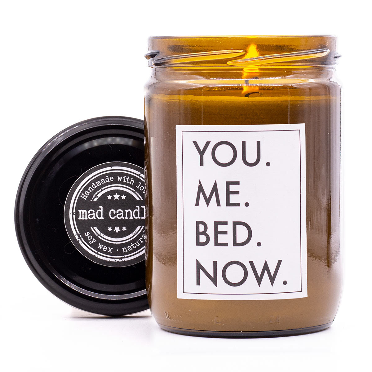 mad candle Duftkerze ‚You. Me. Bed. Now.‘ – vegane Sojawachs-Kerze mit geöffnetem Deckel & brennendem Docht. Ideal als Geschenk für romantische Momente zu zweit. Handgemachte Wellness-Duftkerze fürs Schlafzimmer.