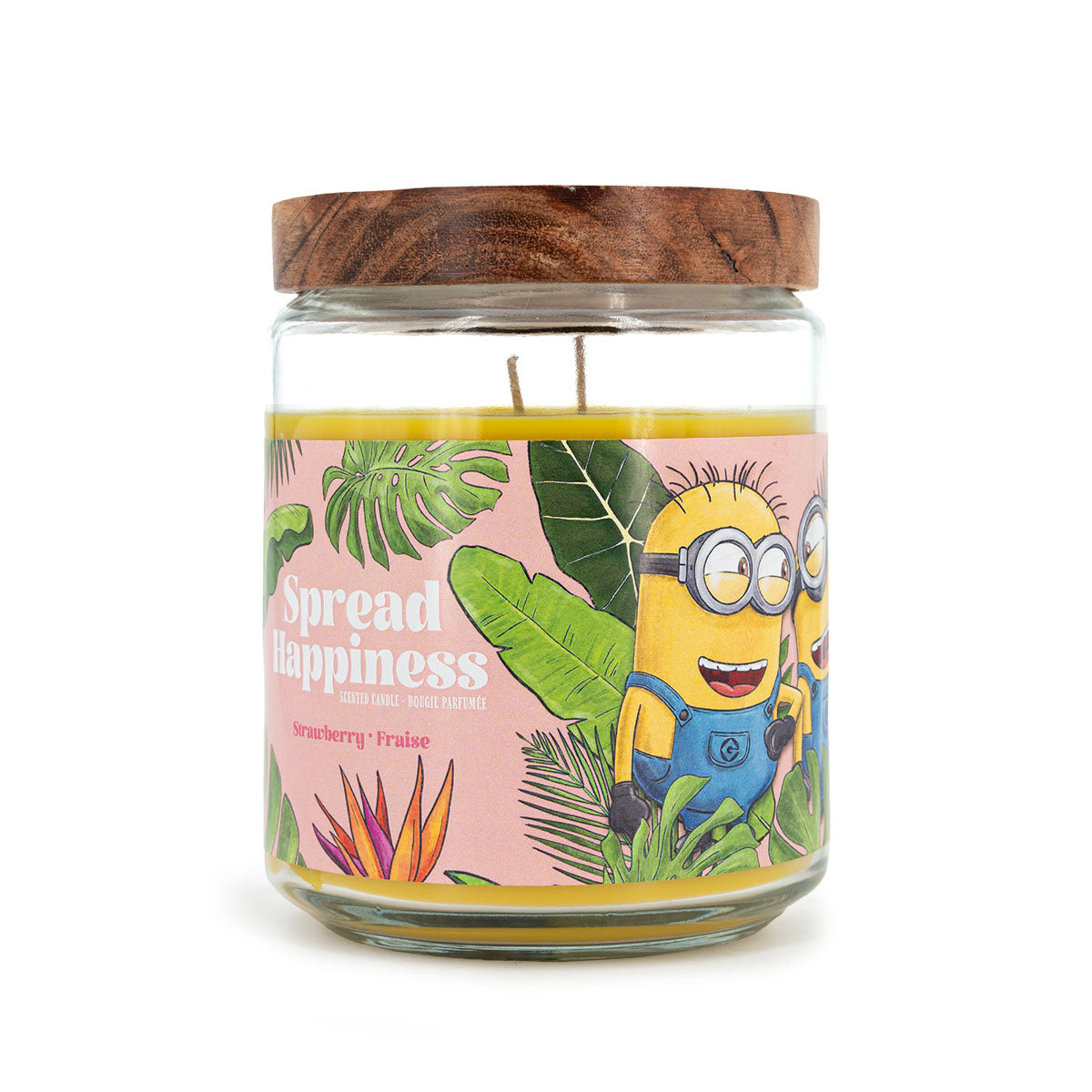 Minions Duftkerze ‚Spread Happiness‘ (510g) – Seitenansicht der offiziellen Lizenzkerze mit lachendem Minion-Design, Palmen und orangefarbenem Hintergrund. Tropische Wellness-Duftkerze im Glas, perfekt als Geschenk oder Deko für Filmfans.